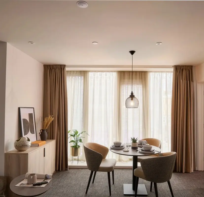 View of a dining space in a co-living apartment for students at Acer