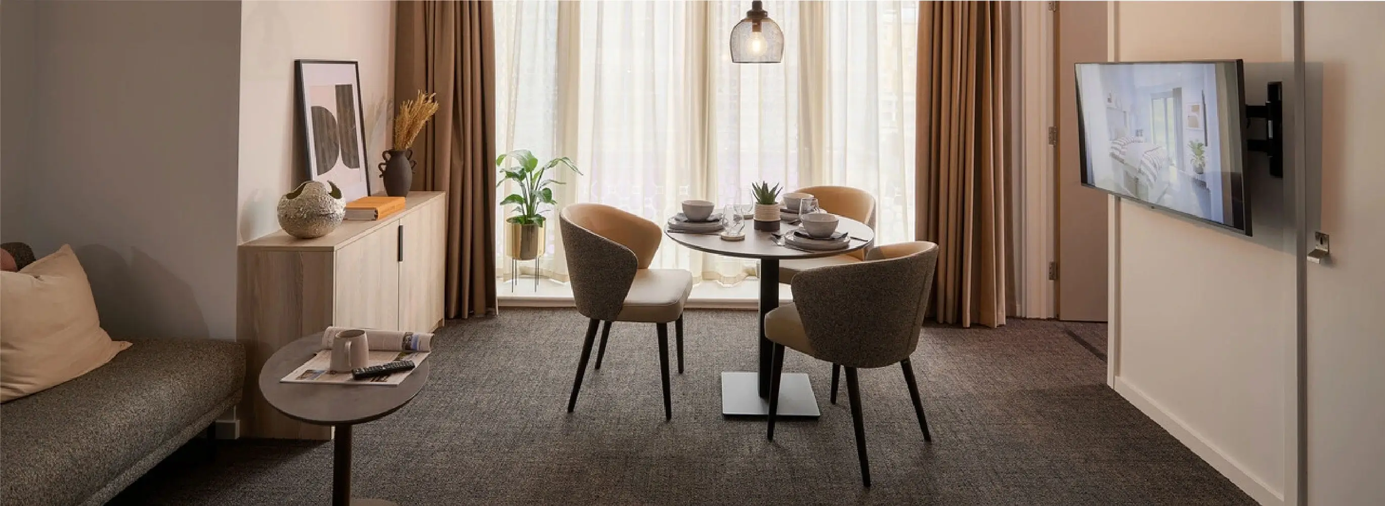 View of a dining space in a co-living apartment for students at Acer